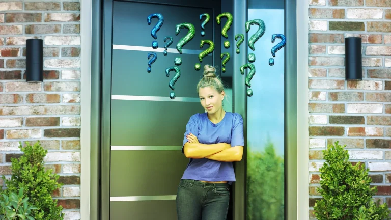 Woman standing at her front door, arms folded, with question marks above head