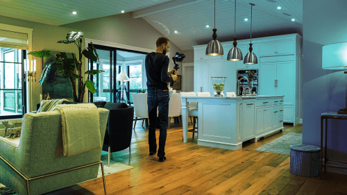 Location scout photographing inside of host home